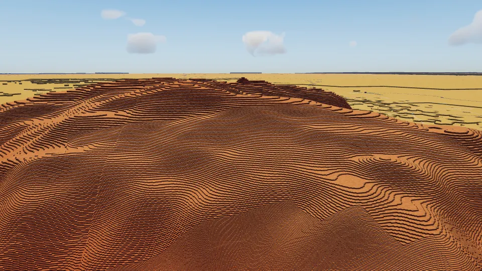 Red voxel terrain at Uluru under the midday sun